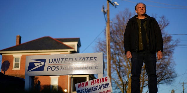 Gerald Groff, a former postal worker whose case will be argued before the Supreme Court, stands during a television interview near a "Now Hiring" sign posted at the roadside at the United State Postal Service, Wednesday, March 8, 2023, in Quarryville, Pennsylvania.