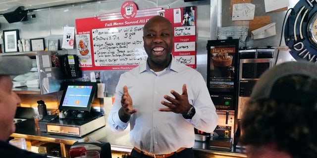 Sen. Tim Scott, R-S.C., talks with diners at the breakfast counter during a visit to the Red Arrow Diner, Thursday, April 13, 2023, in Manchester, N.H. Scott on Wednesday launched an exploratory committee for a 2024 GOP presidential bid.