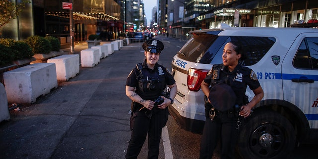 NYPD Officers guard outside Trump Tower in New York on April 12, 2023 as former US President Donald Trump who is scheduled to return to New York City.