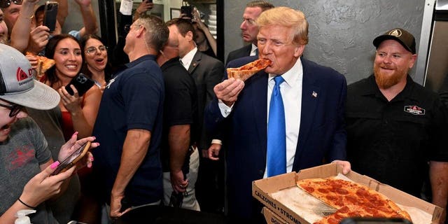 Trump eating slice of pizza