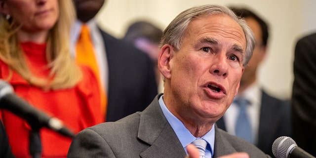 Gov. Greg Abbott, R-Texas, speaking into microphone