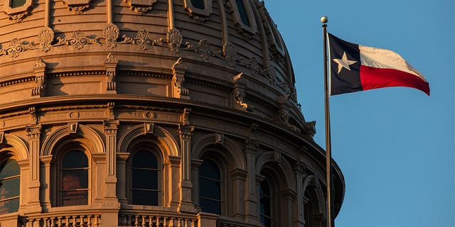 Texas Capitol dome with Texas state flag