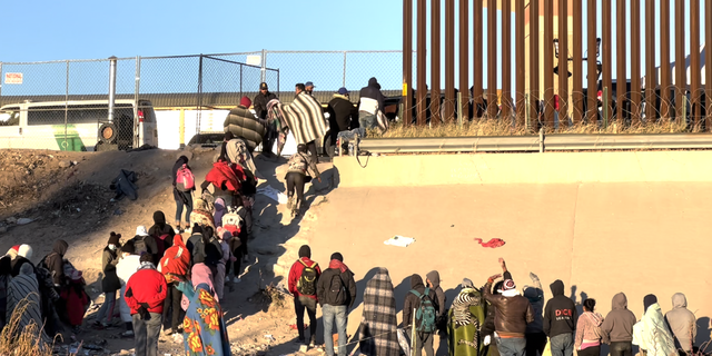 Migrants standing in line at the Border