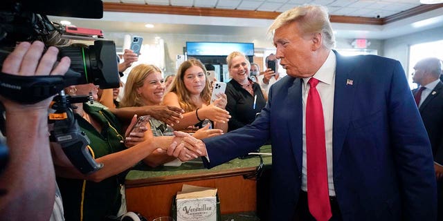 Donald Trump greets supporters at Versailles restaurant