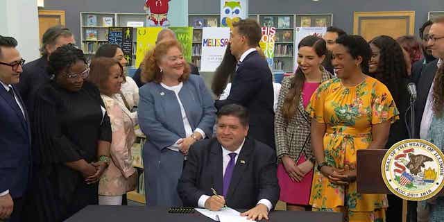 Illinois Gov. JB Pritzker signing a bill