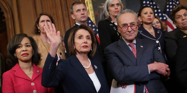 (L-R) Rep. Lisa Blunt Rochester, D-Del., Rep. Nancy Pelosi, D-Calif., Sen. Chuck Schumer, D-N.Y., and other congressional Democrats hold a rally and news conference ahead of a House vote on health care and prescription drug legislation in the Rayburn Room at the U.S. Capitol on May 15, 2019 in Washington, D.C.