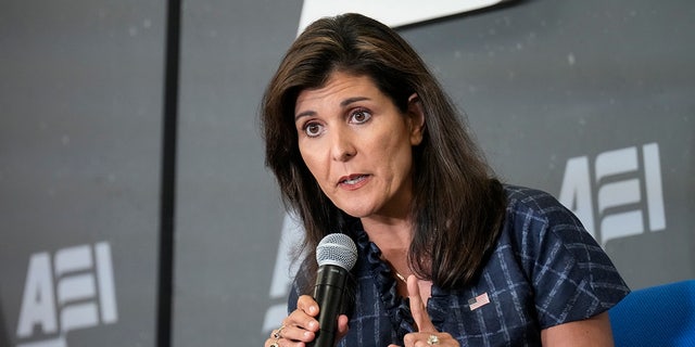 Haley speaks through a microphone at the American Enterprise Institute