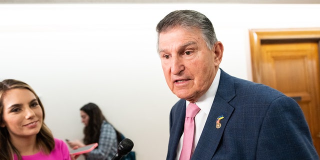 Joe Manchin talks to reporters