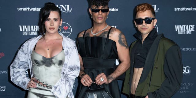 Rose Montoya, a transgender activist who is biologically male, stands next to two other transgender activists.