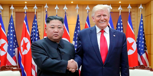 Trump shaking Kim Jong Un's hand