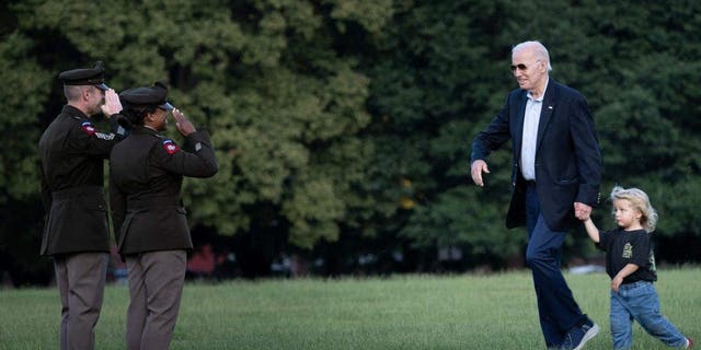 Joe Biden walks with his grandson Beau Biden after arriving on Marine One