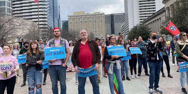 Transgender advocates holding signs