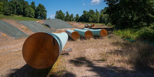 BENT MOUNTAIN, VIRGINIA - AUGUST 31: Sections of 42 diameter sections of steel pipe of the Mountain Valley Pipeline, MVP, lie on wooden blocks, August 31, 2022 in Bent Mountain, Virginia. The MVP will transport natural gas through 303 miles of West Virginia and Virginia. Public opposition has centered on challenging MVPs permitting through wetlands and national forests. The original budget of $3.5 billion is now estimated to be $6.2 billion. The Federal Energy Regulatory Control agency, FERC, has recently granted MVP another 4-years to complete. (Photo by Robert Nickelsberg/Getty Images)