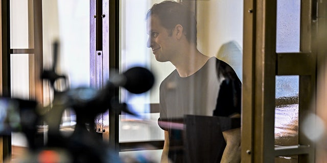 Evan Gershkovich seen behind glass in Moscow court