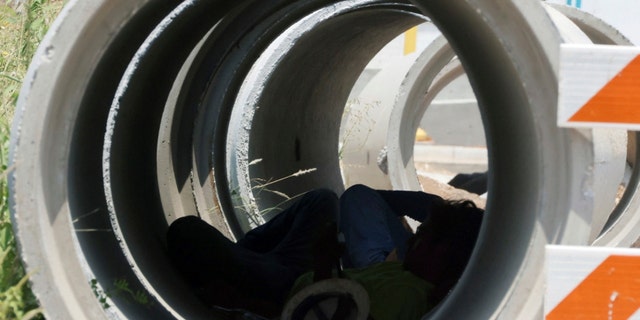 A construction worker takes a break from the sun