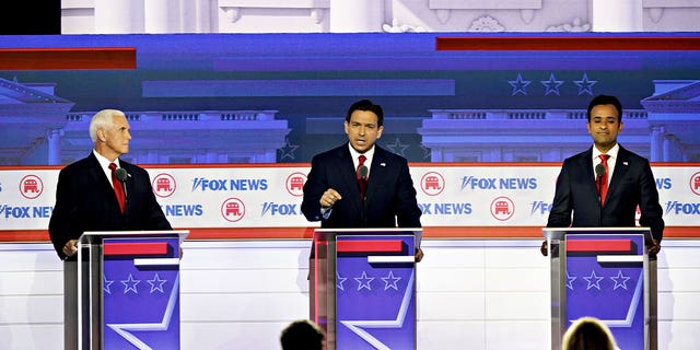 Former Vice President Mike Pence, 2024 Republican presidential candidate, from left, Ron DeSantis, governor of Florida and 2024 Republican presidential candidate, and Vivek Ramaswamy, chairman and co-founder of Strive Asset Management and 2024 Republican presidential candidate, during the Republican primary presidential debate hosted by Fox News in Milwaukee, Wisconsin, US, on Wednesday, Aug. 23, 2023. Republican presidential contenders are facing off in their first debate of the primary season, minus frontrunner Donald Trump, who continues to lead his GOP rivals by a double-digit margin. Photographer: Al Drago/Bloomberg via Getty Images