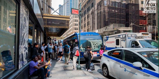 Migrants arrive at the Roosevelt Hotel in Manhattan