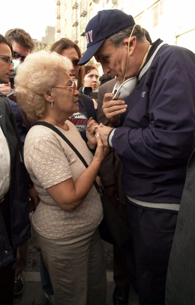 New York City Mayor Rudolph Giuliani consoles Anita Deblase, of New York, whose son, James Deblase, 44, is missing, at the site of the World Trade Center disaster, Wednesday, Sept. 12, 2001. "He's at the bottom of the rubble," she said. James Deblase worked for Cantor Fitzgerald at the World Trade Center. (AP Photo/Robert F. Bukaty)