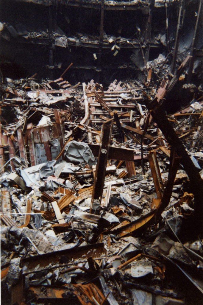 This undated photo of two metal beams, center, that form a cross that rises out of the destruction at the World Trade Center, was made available in New York, Thursday, Oct. 4, 2001. The cast iron "cross," which fell intact from Tower One into nearby Building Six on Sept. 11., was blessed on Thursday by Rev. Brian Jordan, a Franciscan priest, as rescue workers who have adopted it as a symbol of faith gathered around to watch. (AP Photo/Pool)