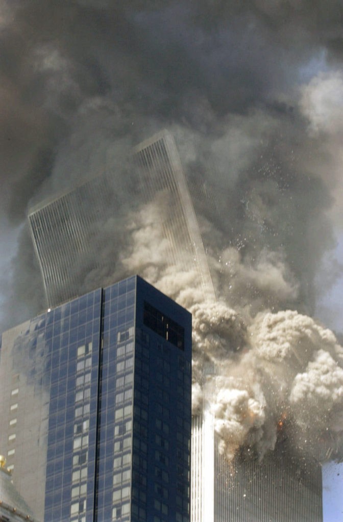 THEN--The south tower of the World Trade Center begins to collapse following the terrorist attack on the New York landmark Tuesday, Sept. 11, 2001. The Millenium Hilton hotel is in foreground. (AP Photo/Amy Sancetta)