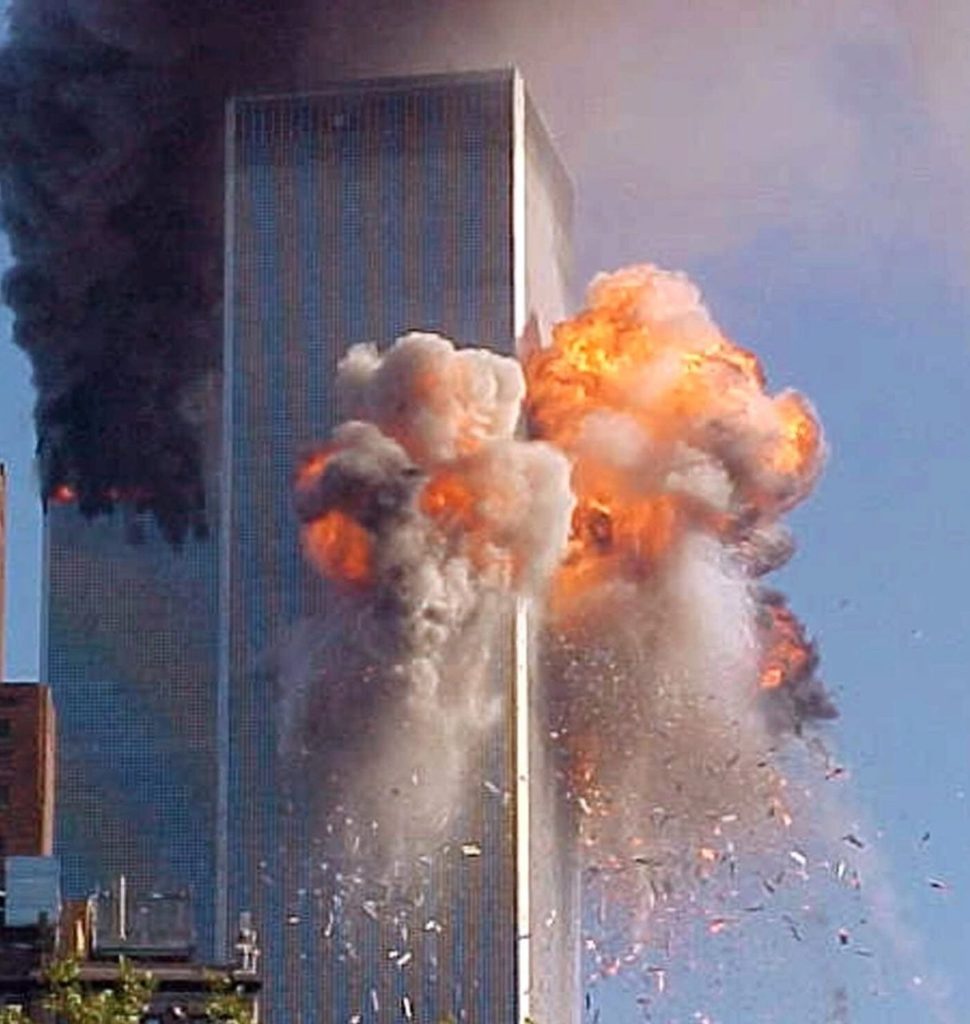 A fireball explodes from one of the World Trade Center towers after a jet airliner crashed into the building Tuesday, Sept. 11, 2001, in New York. (AP Photo/Carmen Taylor)
