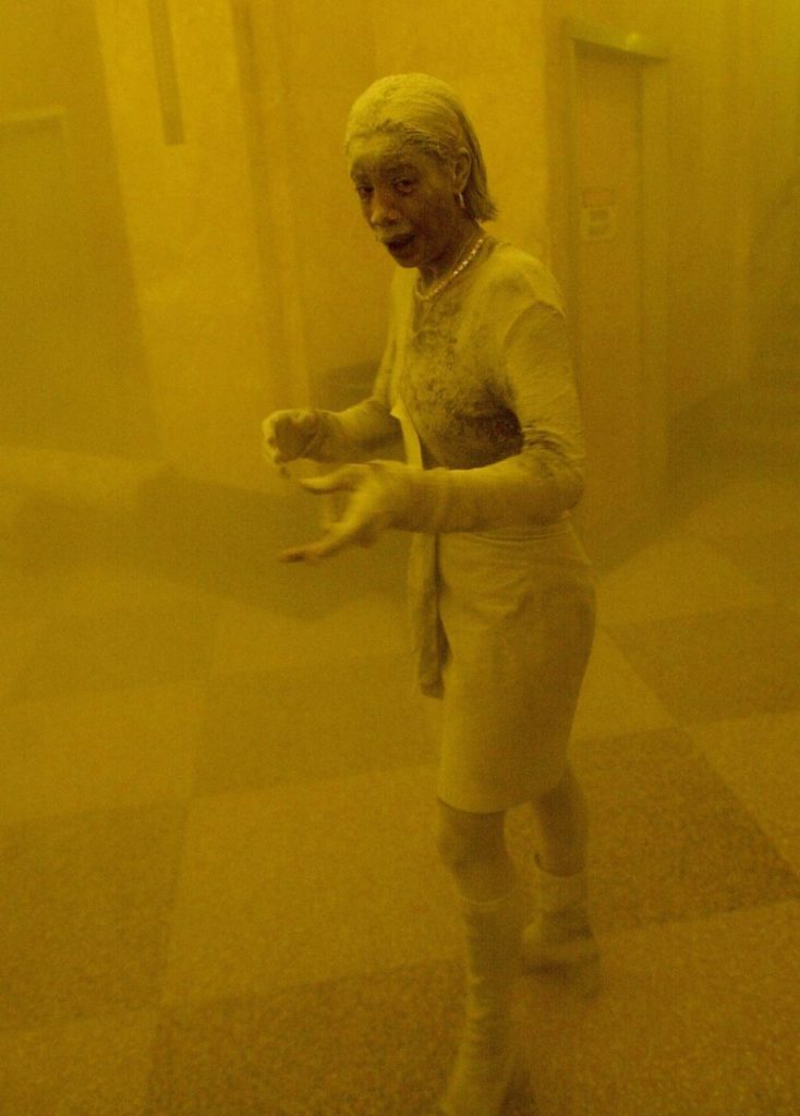 This 11 September 2001 file photo shows Marcy Borders covered in dust as she takes refuge in an office building after one of the World Trade Center towers collapsed in New York. Borders was caught outside on the street as the cloud of smoke and dust enveloped the area. The woman was caught outside on the street as the cloud of smoke and dust enveloped the area. AFP PHOTO/Stan HONDA (Photo credit should read STAN HONDA/AFP/Getty Images)