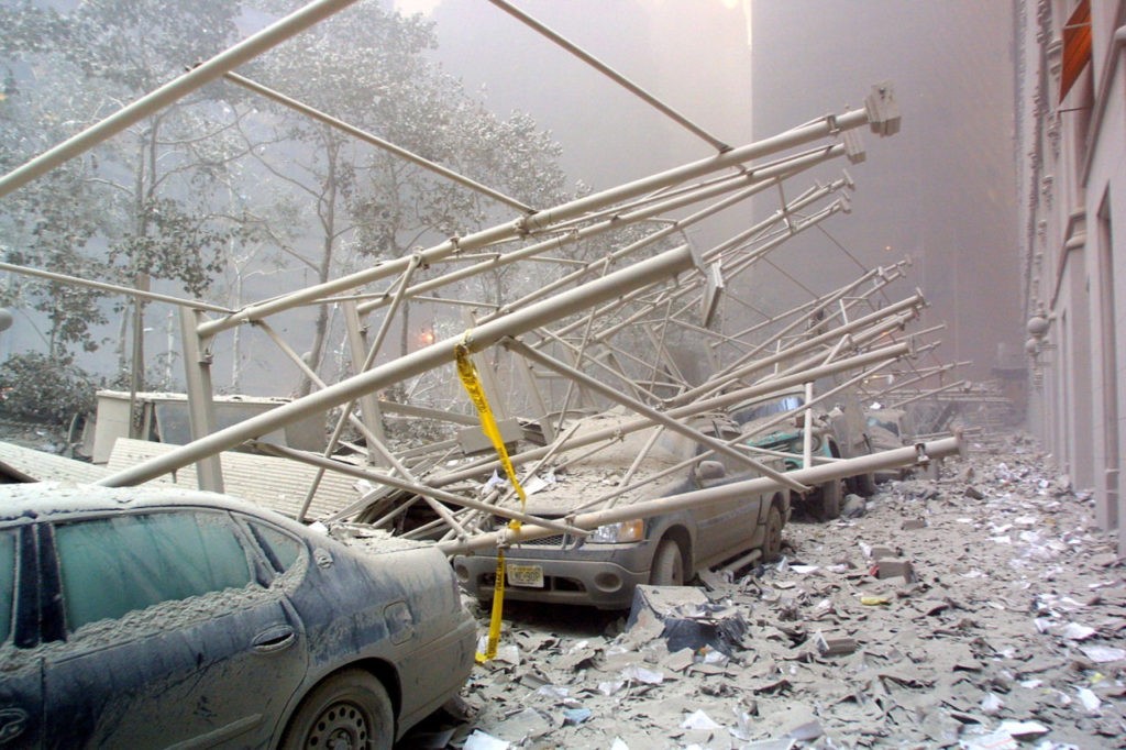 Cars are covered in rubble after the collapse of one of the World Trade Center Towers 11 September, 2001 in New York. US President George W. Bush is to call a meeting of his top national security aides to address terrorist attacks that levelled the World Trade Center and left part of the Pentagon in ruins. AFP PHOTO Doug KANTER (Photo credit should read DOUG KANTER/AFP/Getty Images)