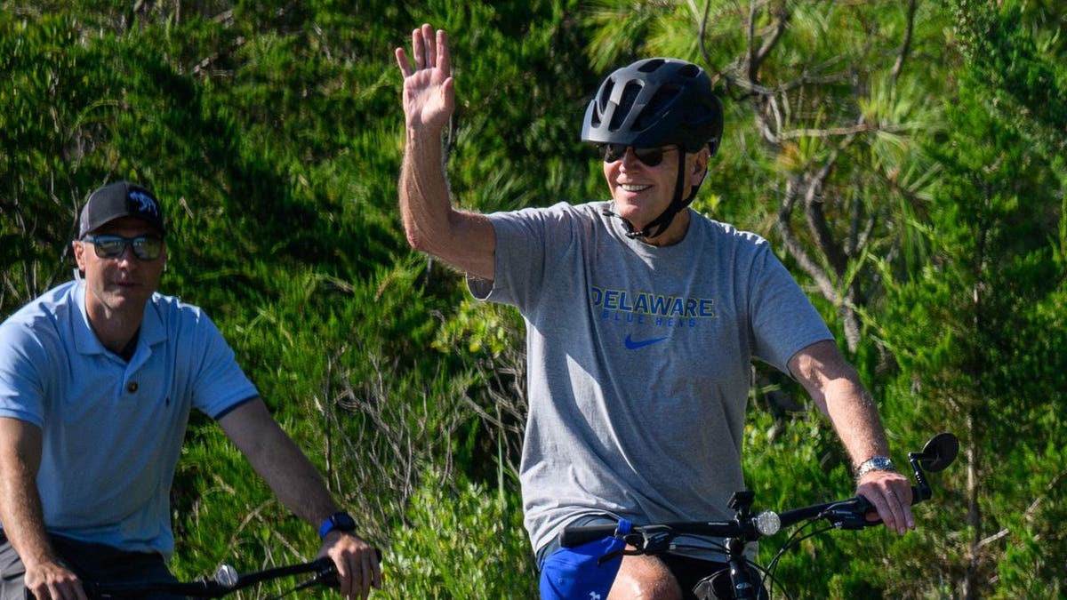 President Joe Biden waves