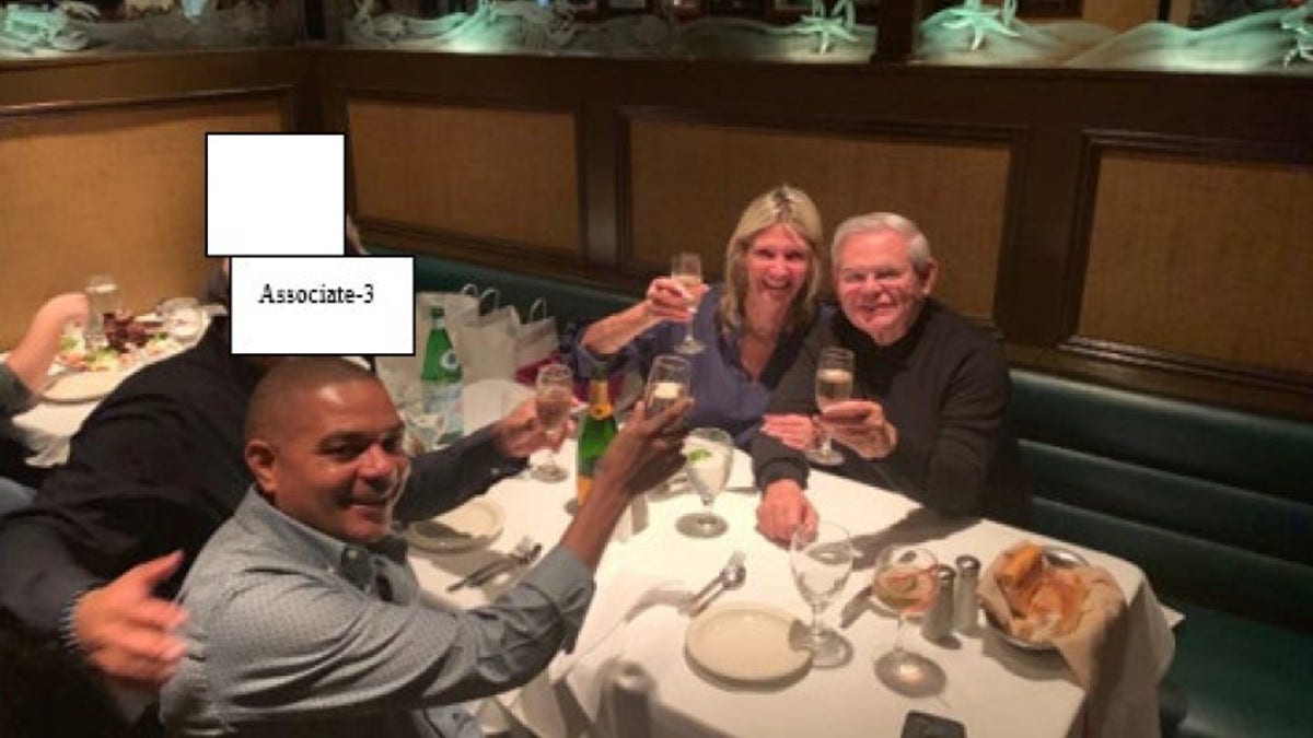 Menendez is pictured with his wife Nadine in 2019 with businessman Jose Uribe, who was also charged Friday, during a celebratory dinner.