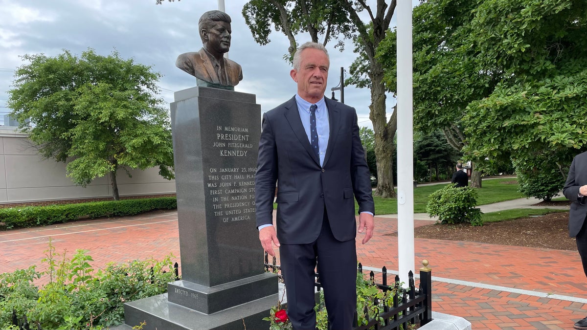 Robert F. Kennedy stands alongside bust of his late uncle, President John F. Kennedy