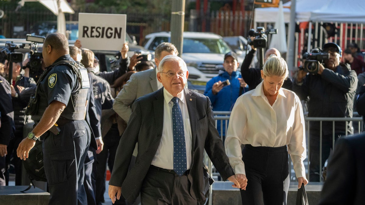 Photographers swarm Menendez couple