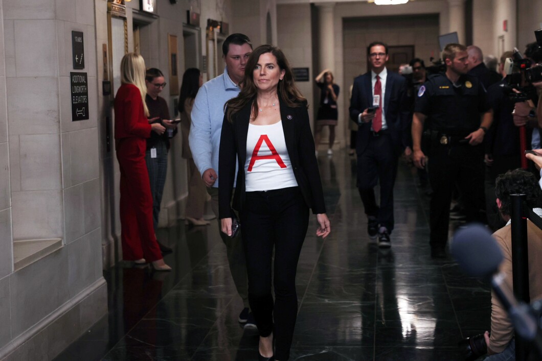 Rep. Nancy Mace (R-SC) walks to the House Republican speakership meeting in the Longworth House Office Building on Capitol Hill, on Oct. 10, 2023. Mace wore a t-shirt with a large red letter A, in an apparent reference to The Scarlet Letter, the 1850 novel by Nathaniel Hawthorne. Mace said it symbolized her being "demonized" for her decision to vote Rep. Kevin McCarthy (R-CA) out of the speakership office. 