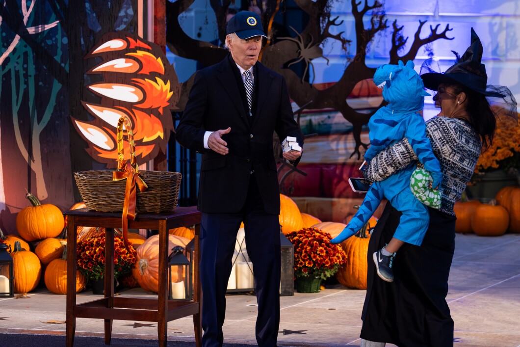 President Joe Biden hands out boxes of chocolates during a Halloween trick-or-treat event on the South Lawn of the White House on Oct. 30, 2023, in Washington, D.C. The president and first lady hosted hundreds of children from public schools and military families for the Halloween event.