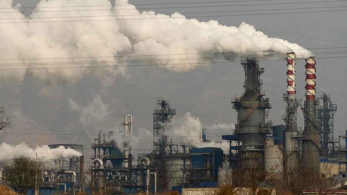 Smoke and steam rise from a coal processing plant