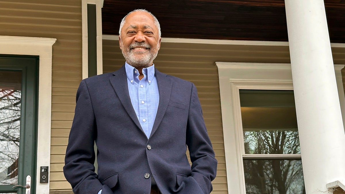 Don Samuels poses outside his home