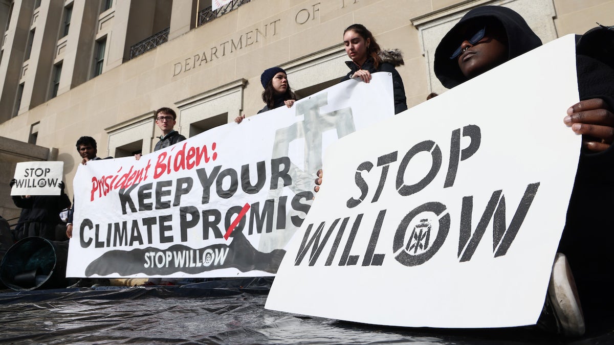 Climate activists hold a demonstration to urge President Biden to reject the Willow Project at the Department of the Interior headquarters on Nov. 17 in Washington, D.C.