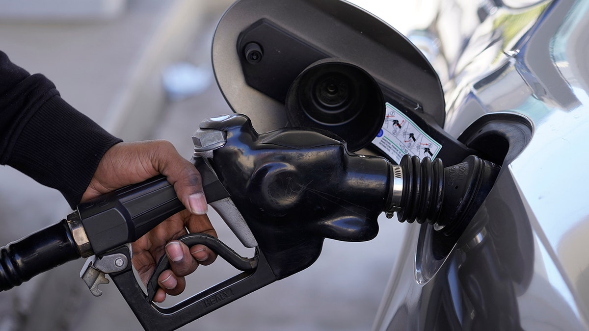 Person fills gas tank in car