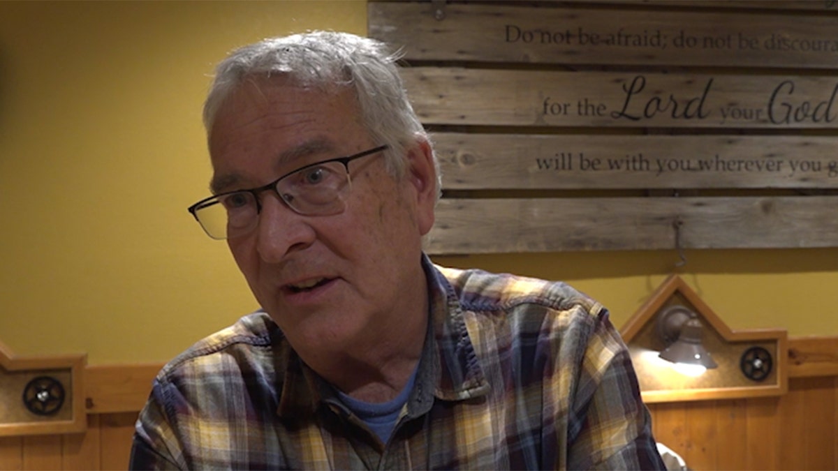 Male voter wearing a flannel talking