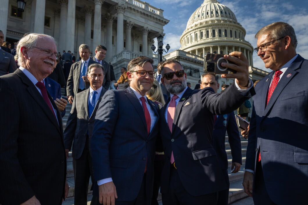 Newly elected Speaker of the House Mike Johnson (R-LA) takes a selfie with Rep. Corey Mills (R-FL) on the East Front steps of the U.S. Capitol on October 25, 2023.