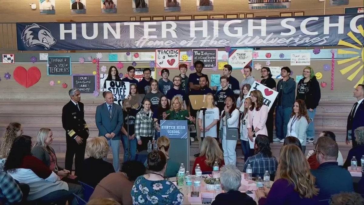 Wide shot of First Lady Jill Biden speaking at Hunter High in school auditorium