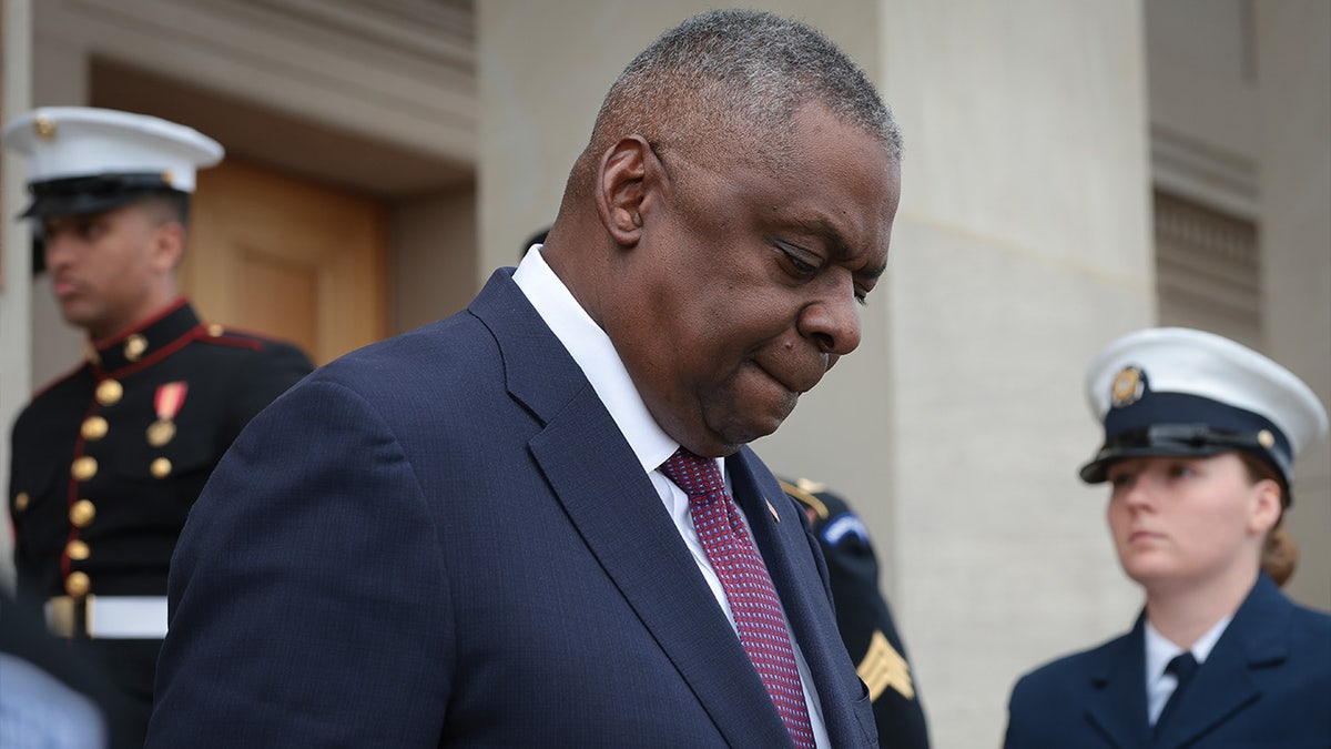 U.S. Secretary of Defense Lloyd Austin walks down the steps