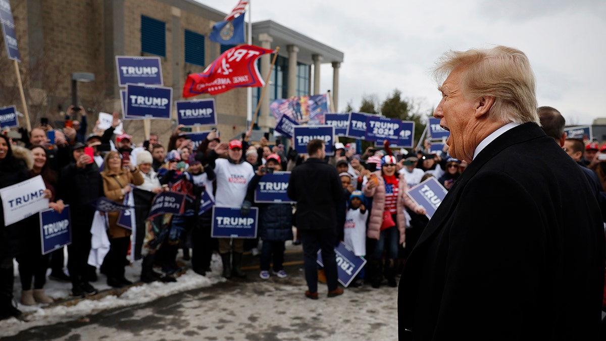 Trump and fans standing outside, crowd with Trump signs