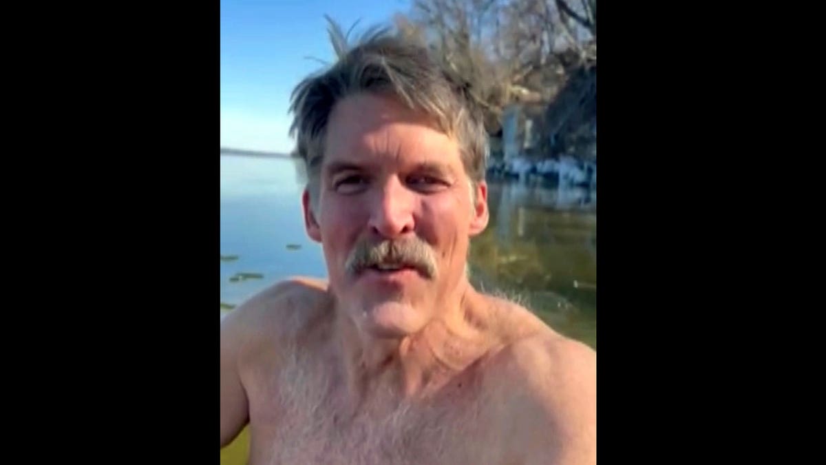 Eric Hovde shirtless in the cold waters of Lake Mendota in Madison, Wis.