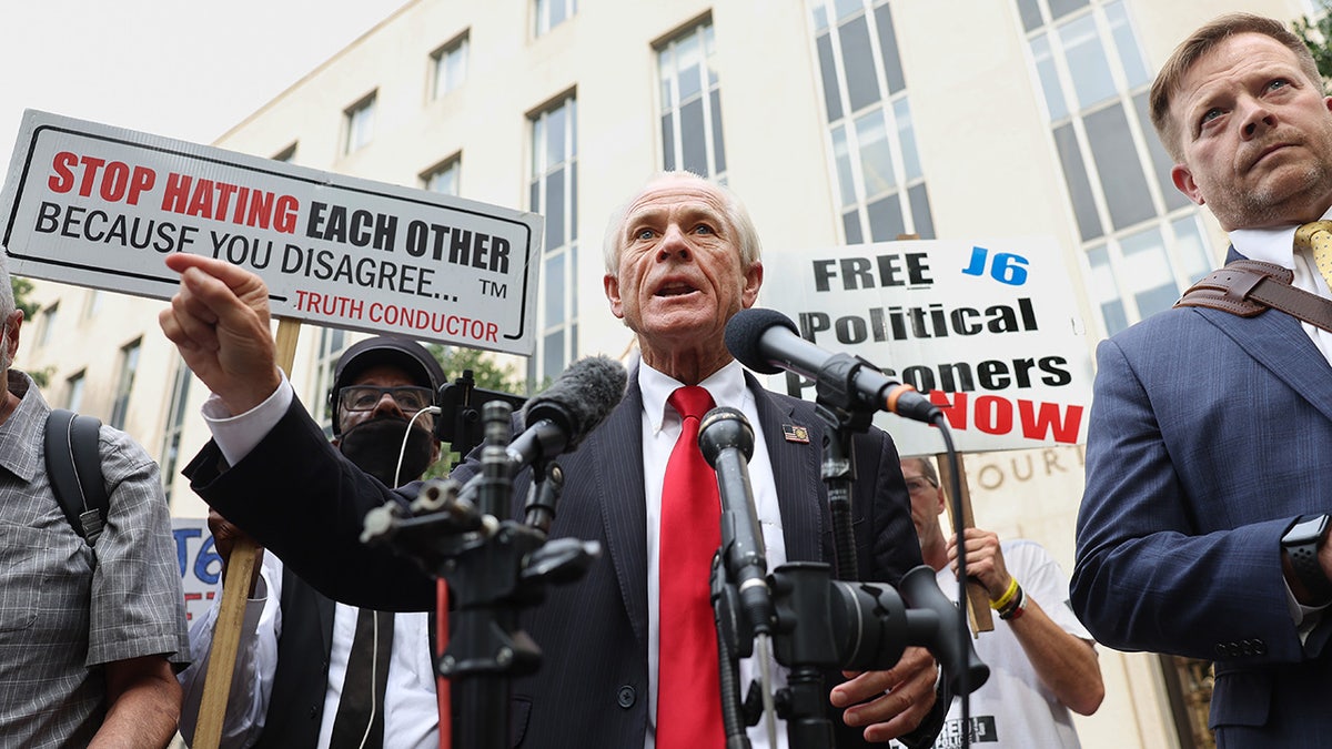 Navarro addresses reporters outside court