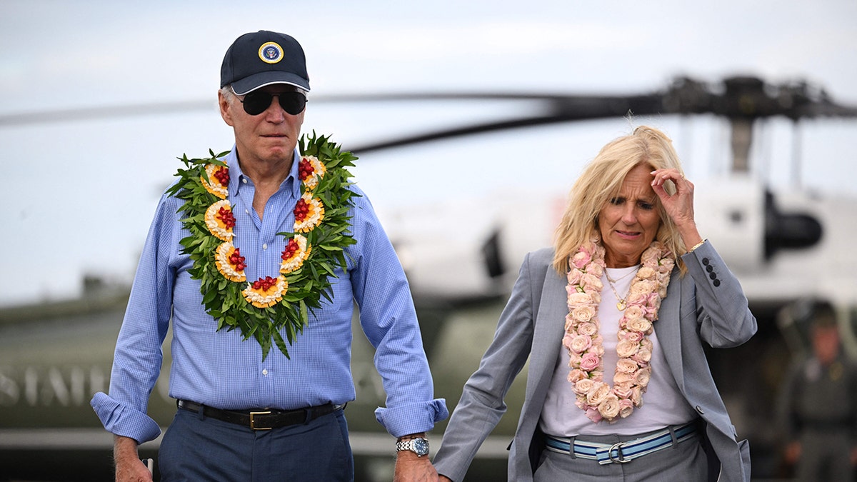 President Biden, left, holding hands with Jill Biden