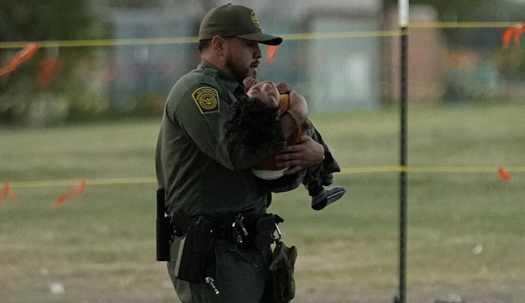 A U.S. Border Patrol agent helps a small migrant child that crossed the Rio Grande from Mexico to the U.S. with a group, Friday, Sept. 22, 2023, in Eagle Pass, Texas.