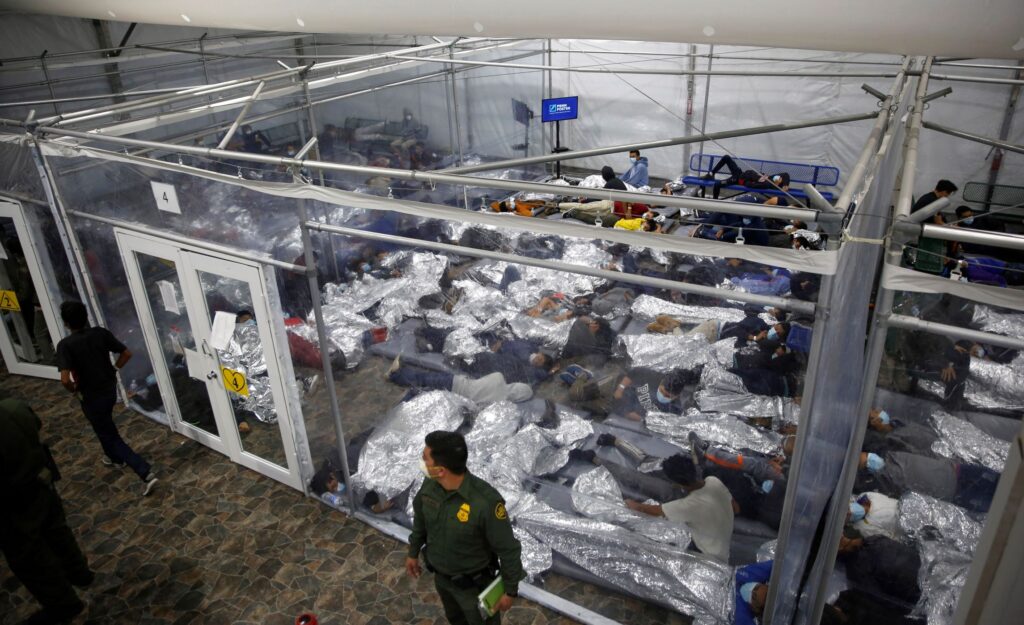 In this March 30, 2021, file photo, minors inside a pod at the Donna Department of Homeland Security holding facility, the main detention center for unaccompanied children in the Rio Grande Valley run by U.S. Customs and Border Protection (CBP), in Donna, Texas