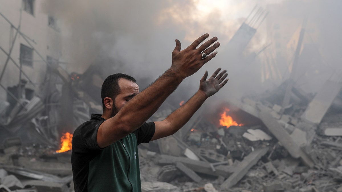 Man with arms raised in Gaza