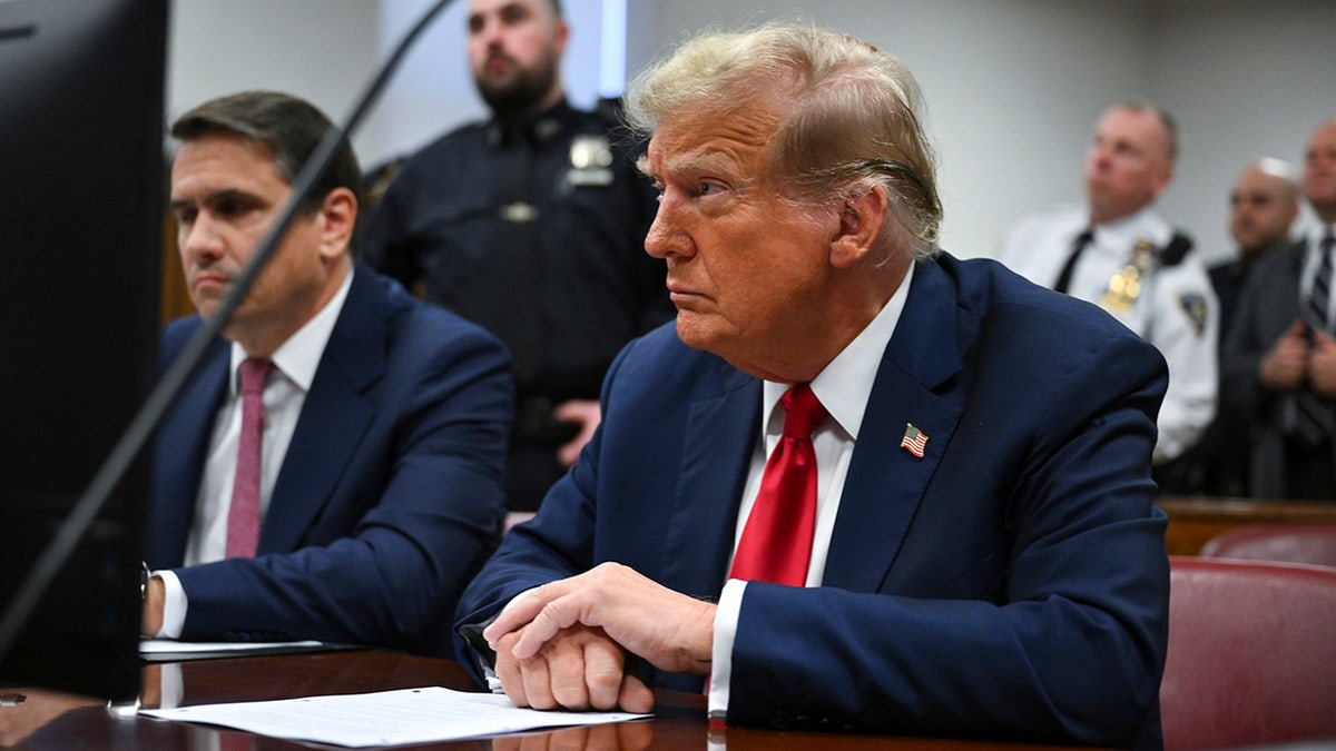 Former President Donald Trump at defense table in courtroom