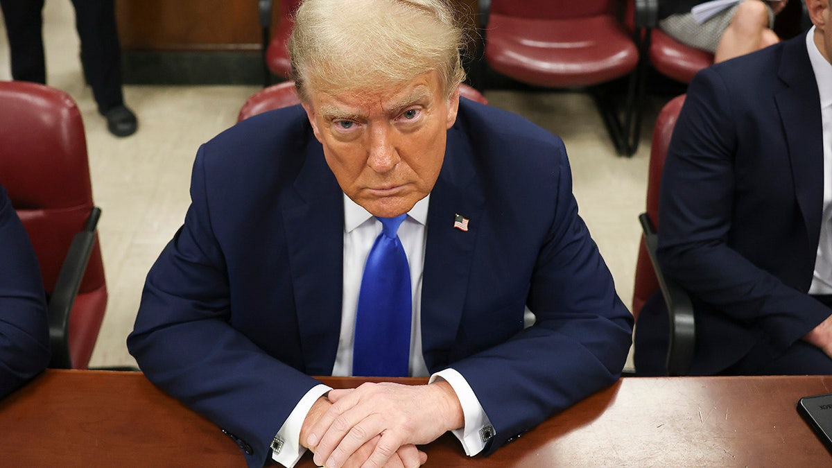 Donald Trump at defense table in courtroom